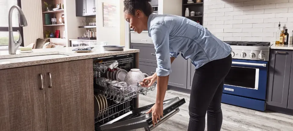 woman loading dishwasher